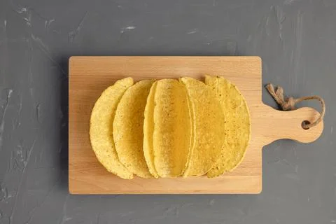 Empty taco shells on board on dark background Foto stock