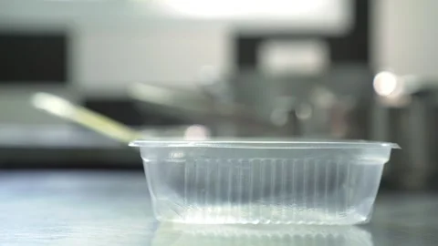 Empty take away container over a restaurant kitchen counter Stock Footage 240785273