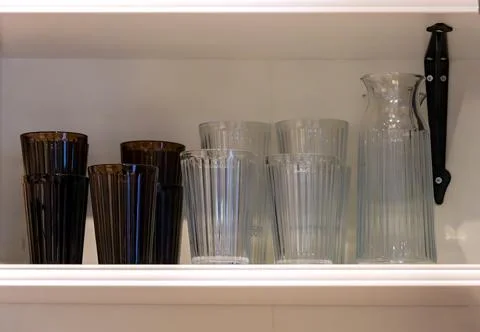 Empty tall glasses inside store shelf interior Stock Photos