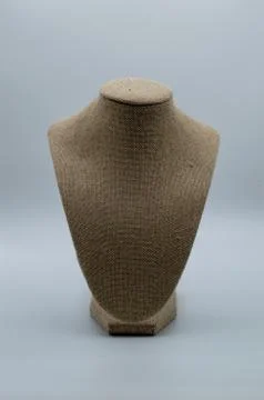 Empty tan torso used to display your jewelry products on gray background Stock Photos