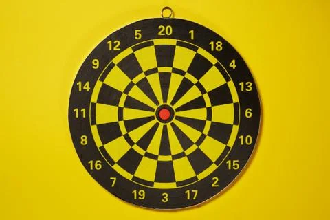 The empty target for a darts - dartboard isolated on yellow background Foto stock