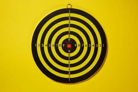 The empty target for a darts - dartboard isolated on yellow background Foto stock