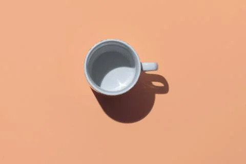 Empty tea cup on beige paper background. Coffee mug from above. Minimal conce Stock Photos