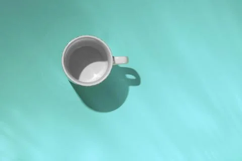 Empty tea cup on blue paper background. Coffee mug from above. Minimal concep Stock Photos