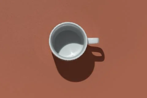 Empty tea cup on brown paper background. Coffee mug from above. Minimal concept Stock Photos