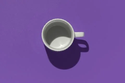 Empty tea cup on violet paper background. Coffee mug from above. Minimal conc Stock Photos