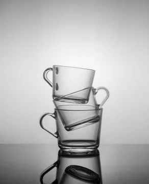 Empty tea mugs stacked on top of each other on dark background Foto stock