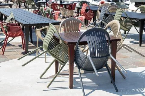 Empty terrace and patio of a closed bar restaurant in sunny day, chairs Stock-Fotos