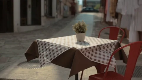 Empty terrace of the cafe in resort town. Lonely empty table of a small resta Stock Footage 163208310