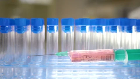 The empty test tube kits on the back of the COVID-19 coronavirus vaccine Stock Footage 127943871