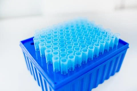 Empty test tubes on in a blue container, white background, copyspace. Laborat Stock Photos