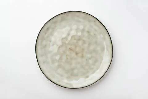 Empty textured plate on white background Stock Photos