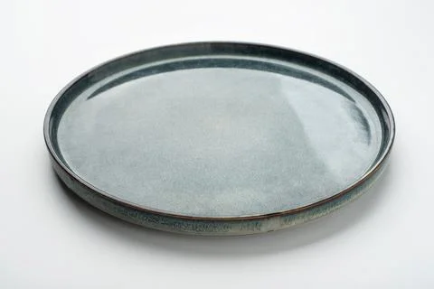 Empty textured plate on white background Stock Photos