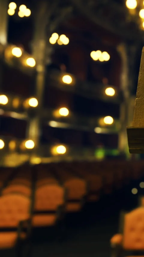 Empty theater with red chairs and dim lights before a performance begins Stock Footage 331765801