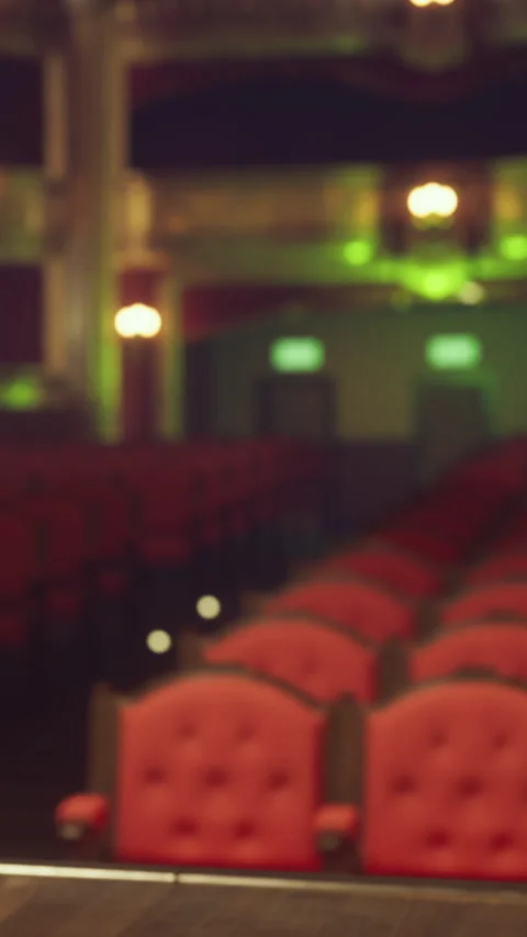 Empty theater seating with red chairs seen from the stage area during an event Stock Footage 340867663