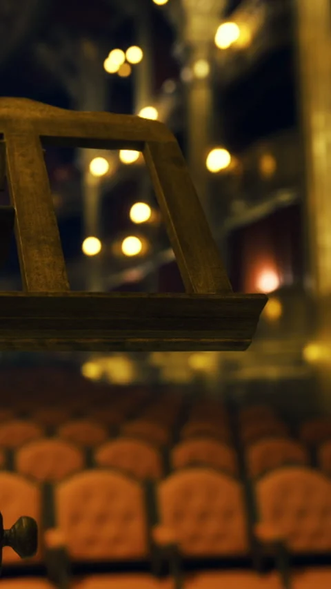 Empty theater seats view with stage lighting in background during performance Stock Footage 331765128