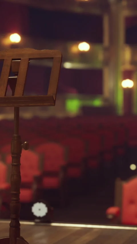 Empty theater stage with music stand and red seats at night Video stock 339505185