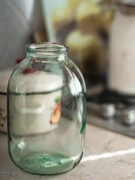 Empty three-liter jar stands on the tabletop Photos