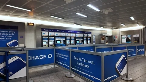 Empty ticket machines line the King's Cross station concourse in London beneath Stock Footage 334329238