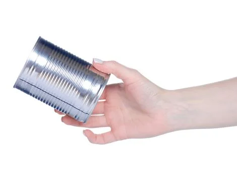 Empty tin can in hand Stock Photos