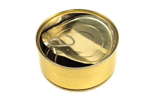 Empty tin can with an open lid on a white background close-up. Tin Can Isolat Stock Photos
