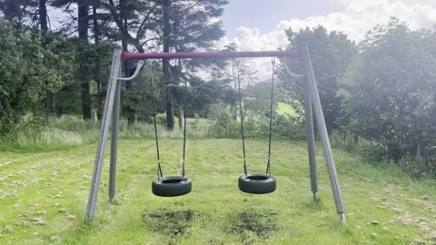 Empty Tire Swings Moving in a Green Garden on a Windy Day Stock Footage 340108983