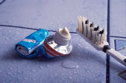 Empty tooth paste and used tooth brush Stock Photos