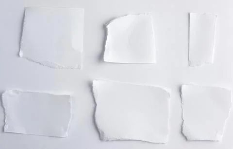 Empty torn pieces of white paper on a white background Stock Photos