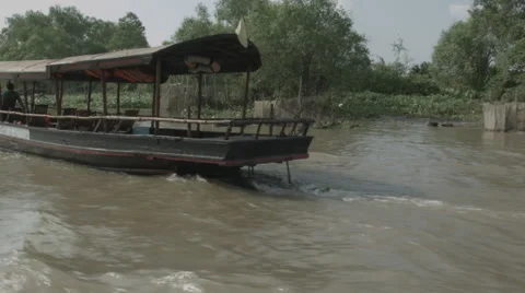 An empty tourist boat cruising down the Mekong River in Vietnam Stock Footage 48154993