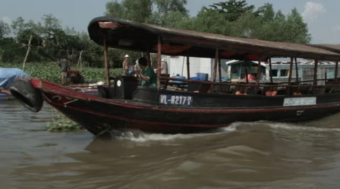 An empty tourist boat cruising down the Mekong River in Vietnam Stock Footage 48155975
