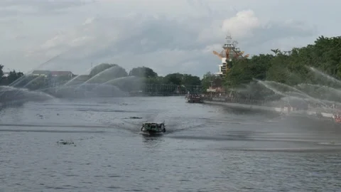 Empty tourists boat under the water spray by firefighters Stock Footage 157462326