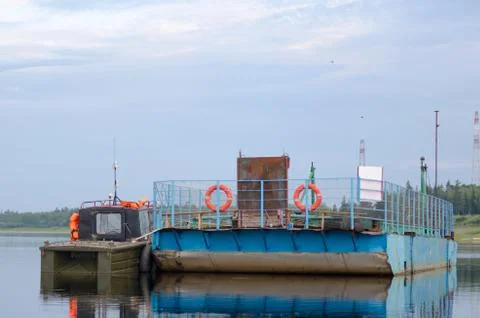 Empty tractor ferry with life jackets and circles stands in the calm water Fotos Stock