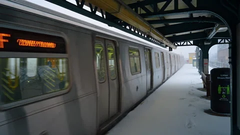 Empty train arrived to the platform covered with snow. View on the elevated Stock Footage 335651264