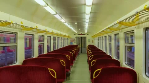 Empty train carriage interior with red seats and bright lighting, Vilnius Stock Footage 340863643