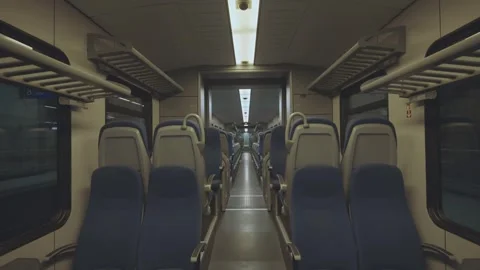 Empty train interior traveling through tunnel with rows of seats in perspec.. Stock Footage 337387820