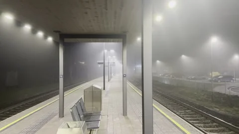Empty train platform on foggy night in Austria Stock Footage 326938443