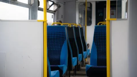 Empty train seats. Blue Colored Train Seats and Warning Signs Stock Photos