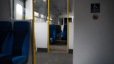 Empty train seats. Blue Colored Train Seats and Warning Signs Stock Photos