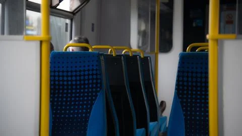 Empty train seats. Blue Colored Train Seats and Warning Signs Stock Photos