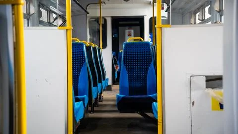 Empty train seats. Blue Colored Train Seats and Warning Signs Stock Photos