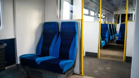 Empty train seats. Blue Colored Train Seats and Warning Signs Stock Photos