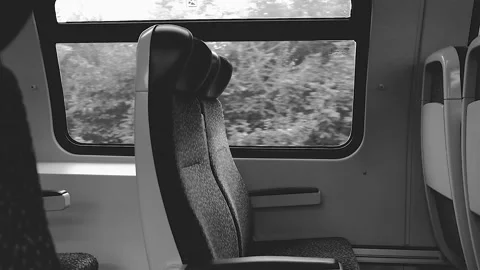 Empty train sits in moving train Stock Footage 138454673