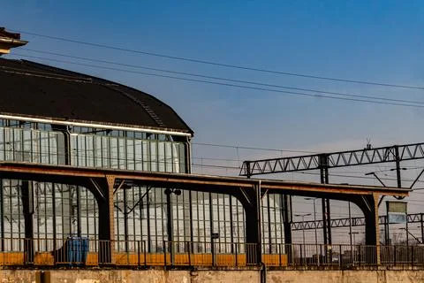 Empty train station with glass building and overhead wires Stock Photos