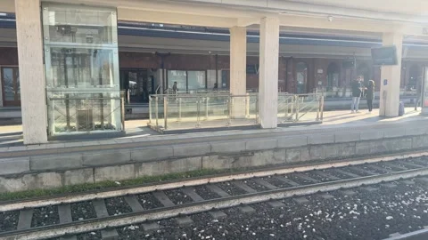Empty train station platform with few passengers waiting Stock Footage 298246775