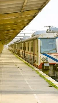 Empty train station platform with an old train ready for departure Stock Photos