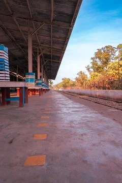 Empty train station with track and surrounding nature Stock Photos