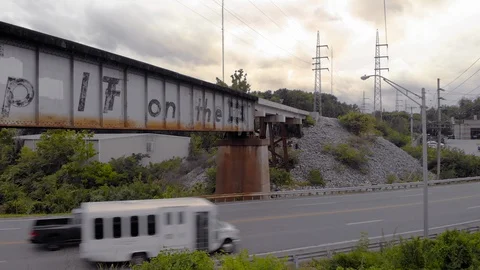 An Empty Train Track Overpass with Traffic Rushing By Stock-Footage 128818617