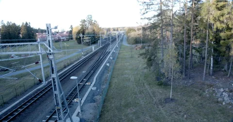 Empty train track with small station in distance 스톡 동영상 163156712