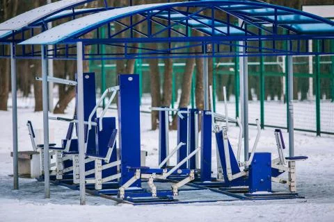 An empty training ground (workout) on the street in winter. Fitness equipment Stock Photos