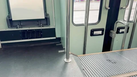 Empty tram interior with doors and step at a stop Stock Footage 343126934